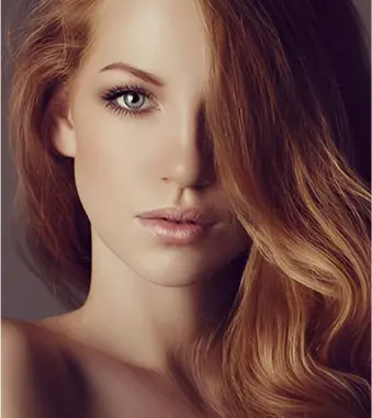 A beautiful woman with long red hair and blue eyes.